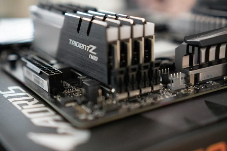 Computer motherboard with DDR5 RAM sticks installed representing why modern apps use so much RAM
